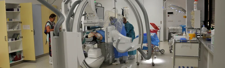 Personál provádí angiografii v operačním sále pomocí rentgenového přístroje.