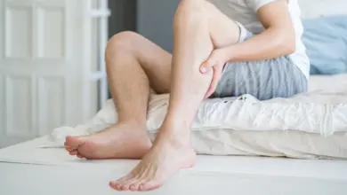 Man holding his leg in pain