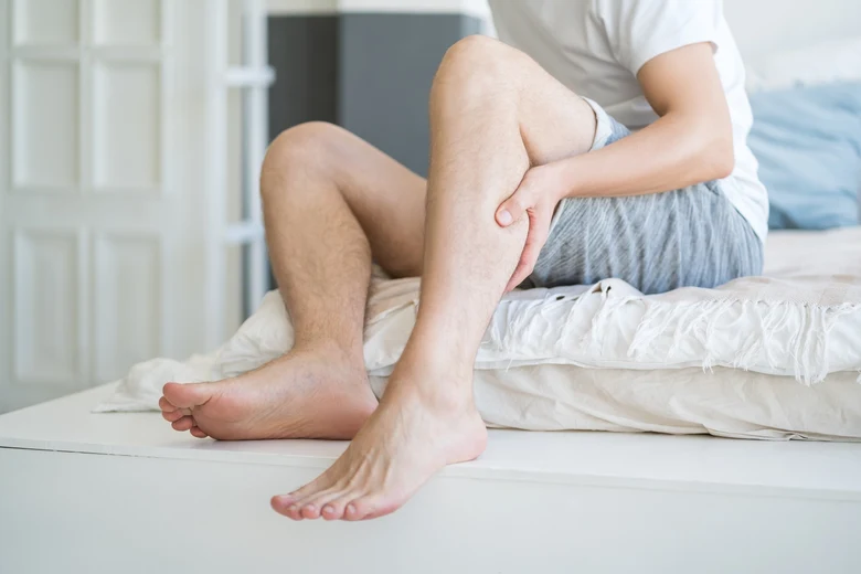 Man holding his leg in pain